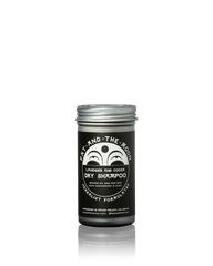 A jar of Fat and the Moon Dry Shampoo in Lavender and Cocoa scent, featuring a black label with white text and a silver metal lid, set against a plain white background with a soft reflection.