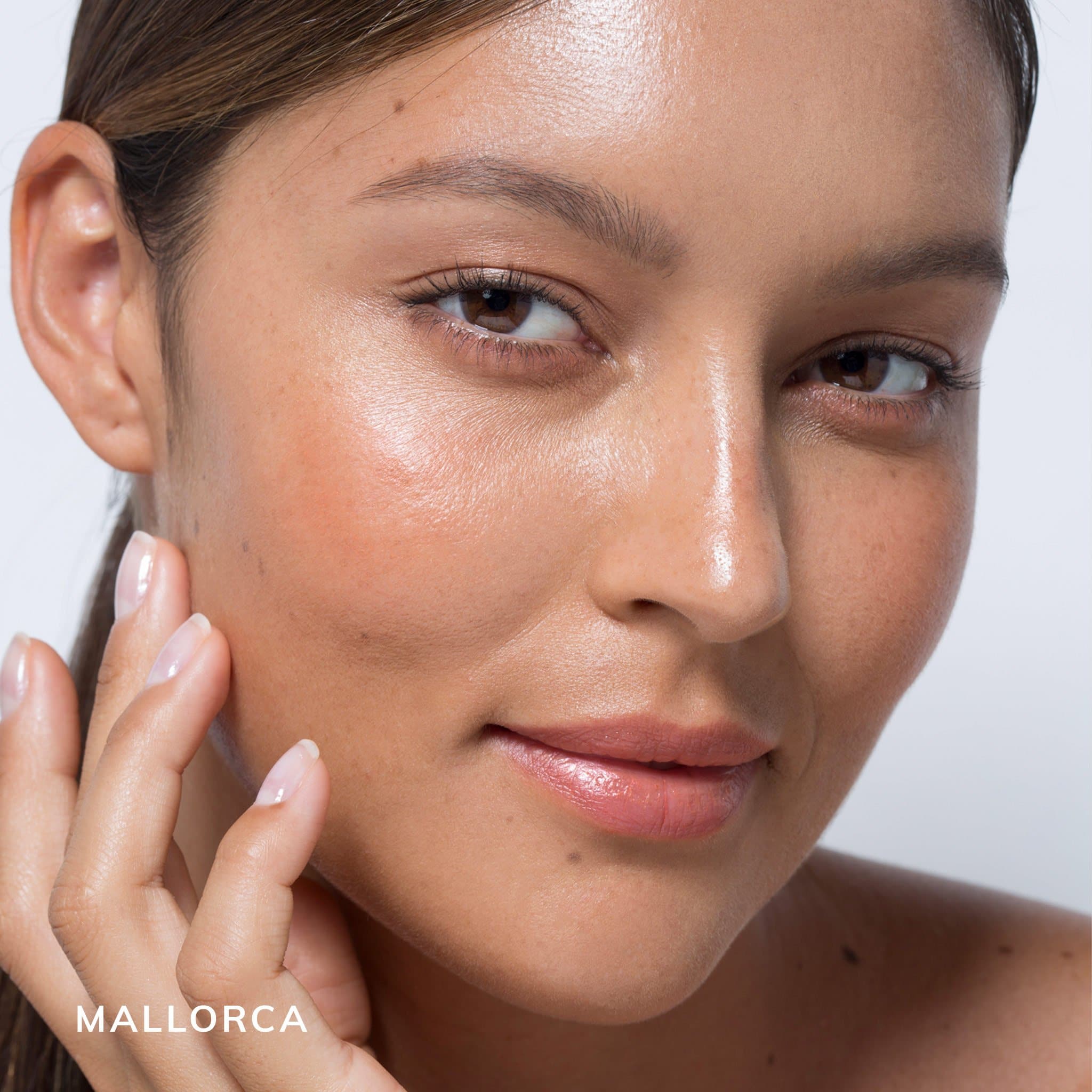 Model featuring au naturale's semi-matte foundation in shade mallorca